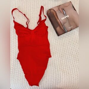 SKIMS Seamless Sculpt Thong Bodysuit in Ruby